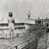 Boy fishing off a tug, with Pete Carlson on the Good Will in the background. Courtesy of Bill Carlson. 